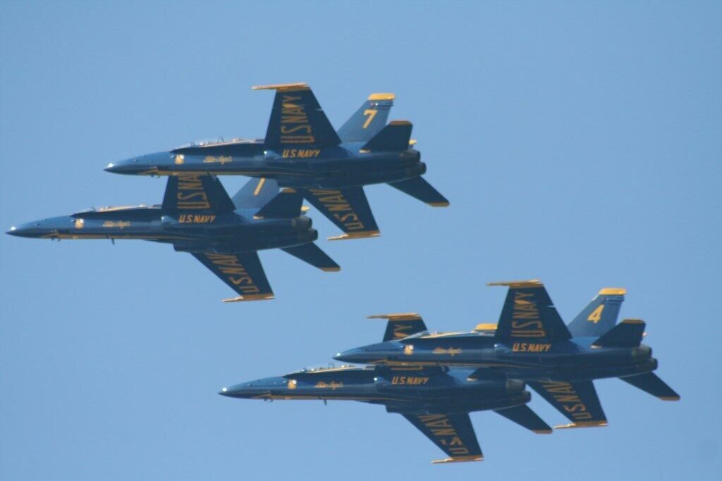 Two US Navy fighter jets flying in formation.