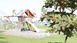 A playground with a climbing structure and slides. - Evasion (Gressier)