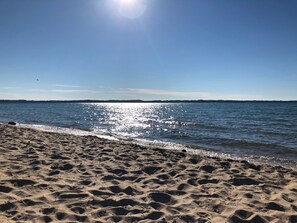 A beach with a clear sky and calm sea. - The Victorian on Pine: Historic Charm. Lake Life Memories. (Elk Rapids)