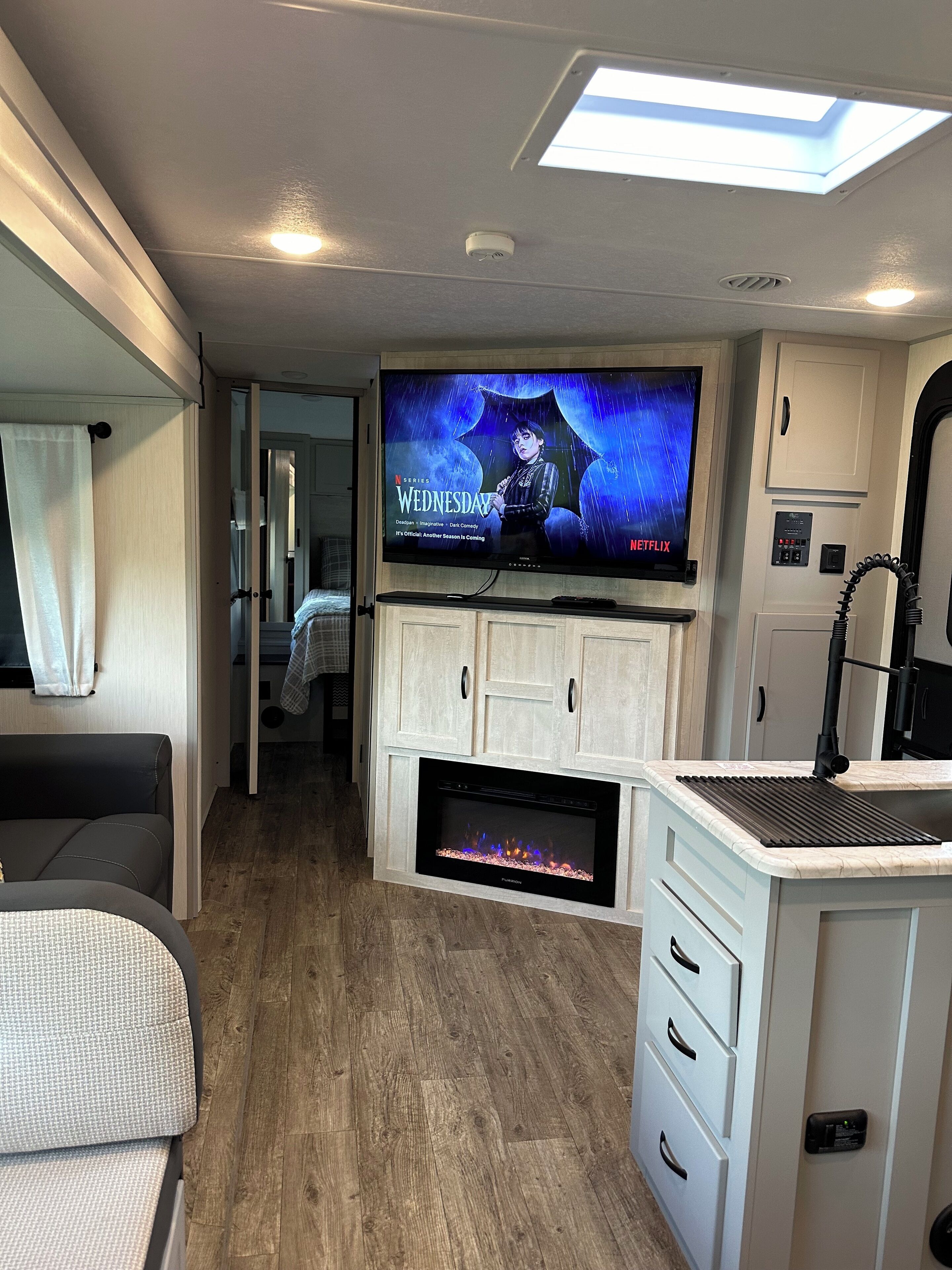 Smart TV, fireplace, books, printers