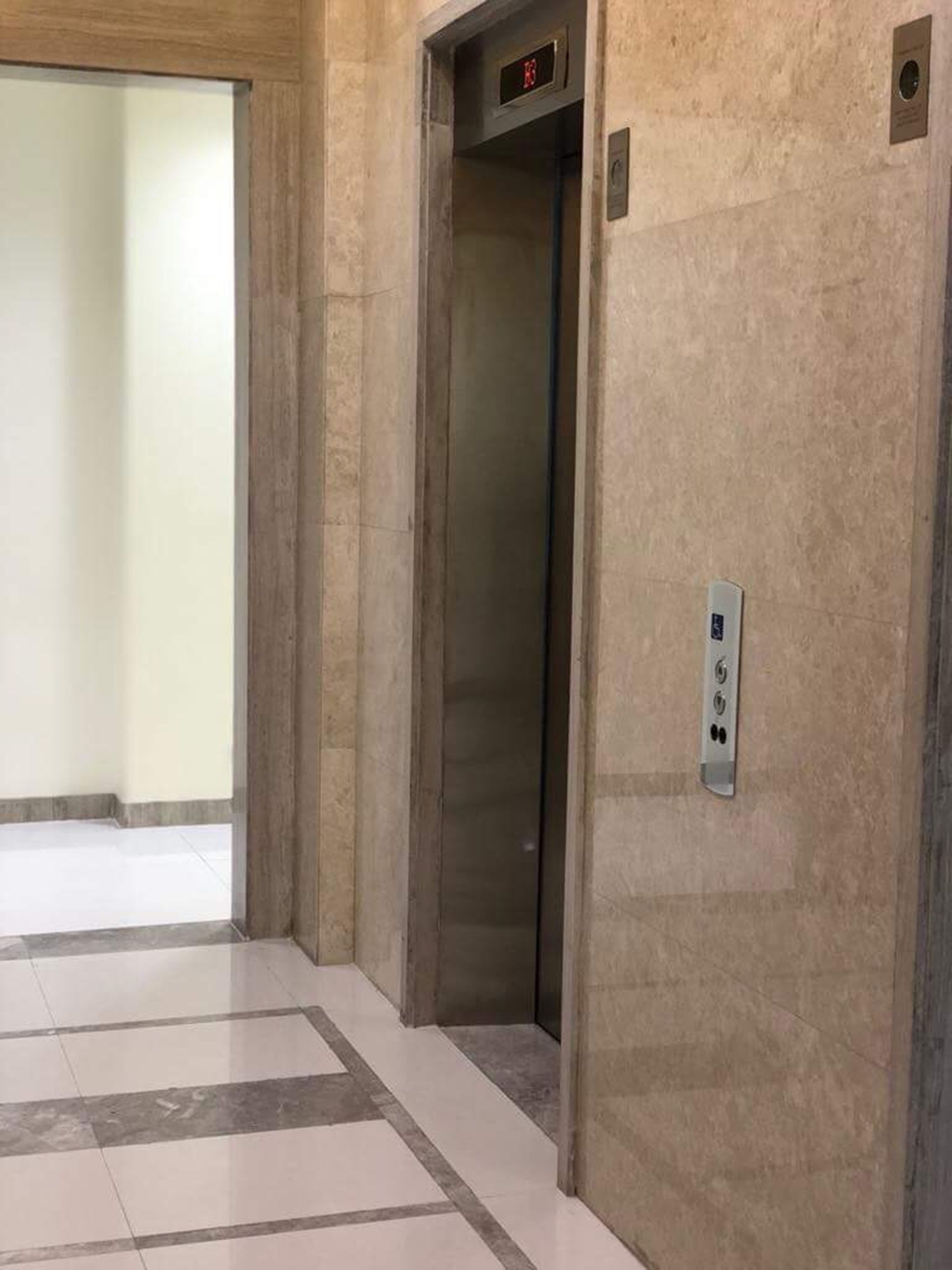 An elevator with a digital display and a control panel.