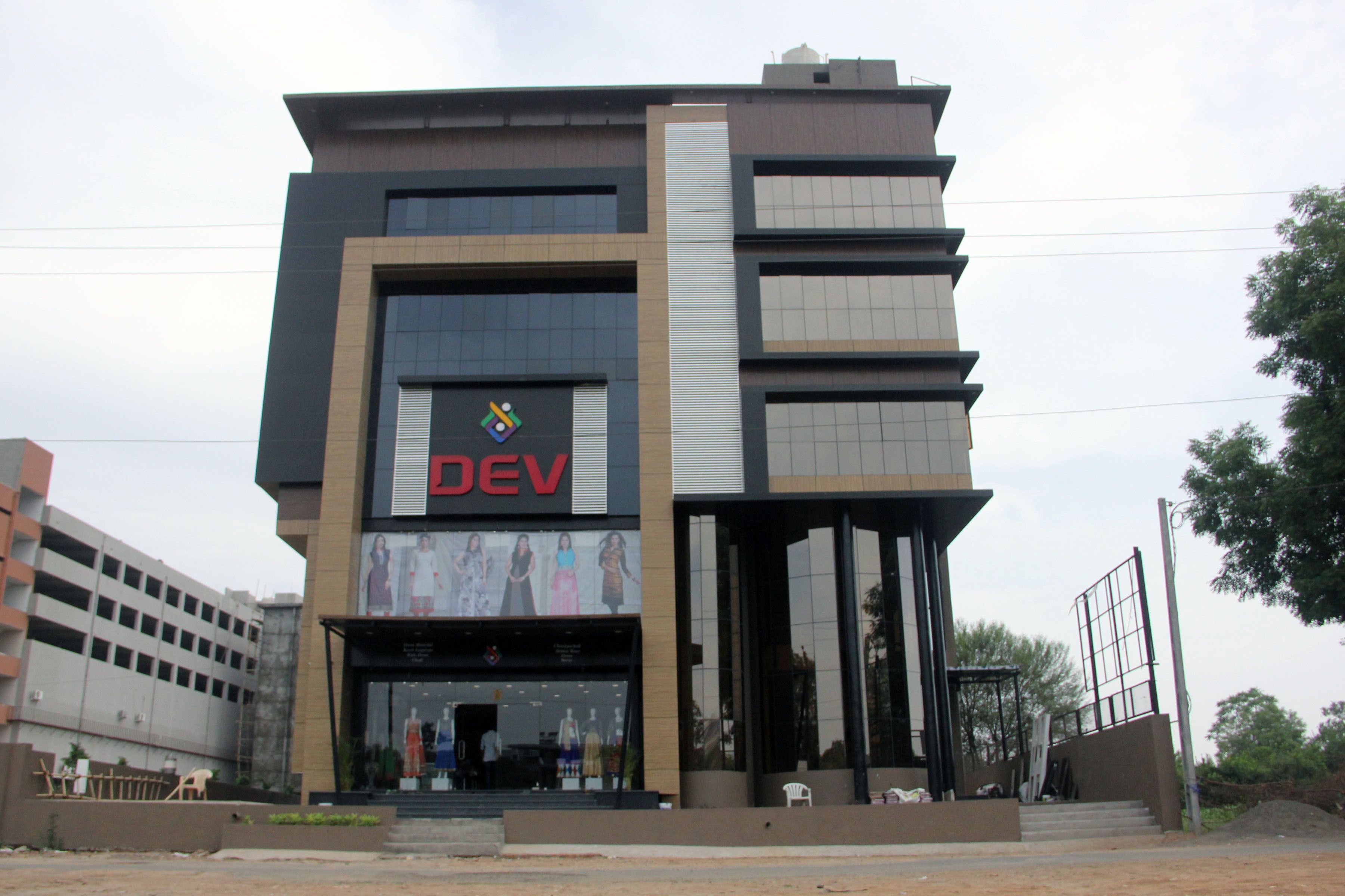 A modern building with a prominent 'DEV' sign, large windows, and a visible entrance.