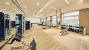 A modern gym with treadmills, weight machines, and dumbbells. - LJZ Supreme Tower Hotel(SHANGHAI New International Expo Centre) (Shanghai)