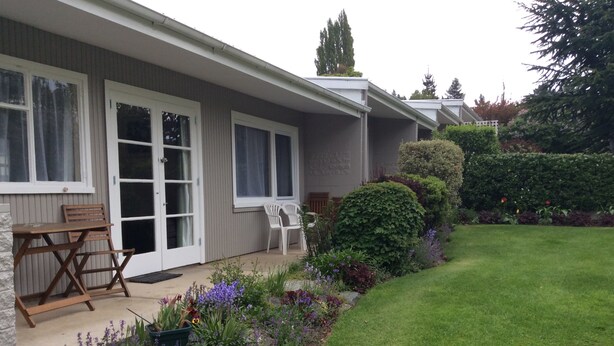 A residential building with a covered patio, outdoor seating, and a well-maintained garden. - Alexandra Garden Court Motel (Alexandra)