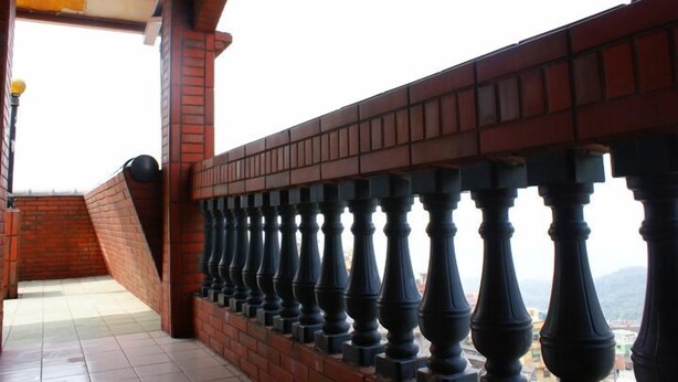 A balcony with a brick wall and black balusters. - Tophome 9 (New Taipei City)