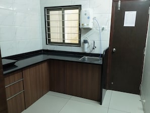 Full-sized fridge, stovetop, rice cooker, cookware/dishes/utensils