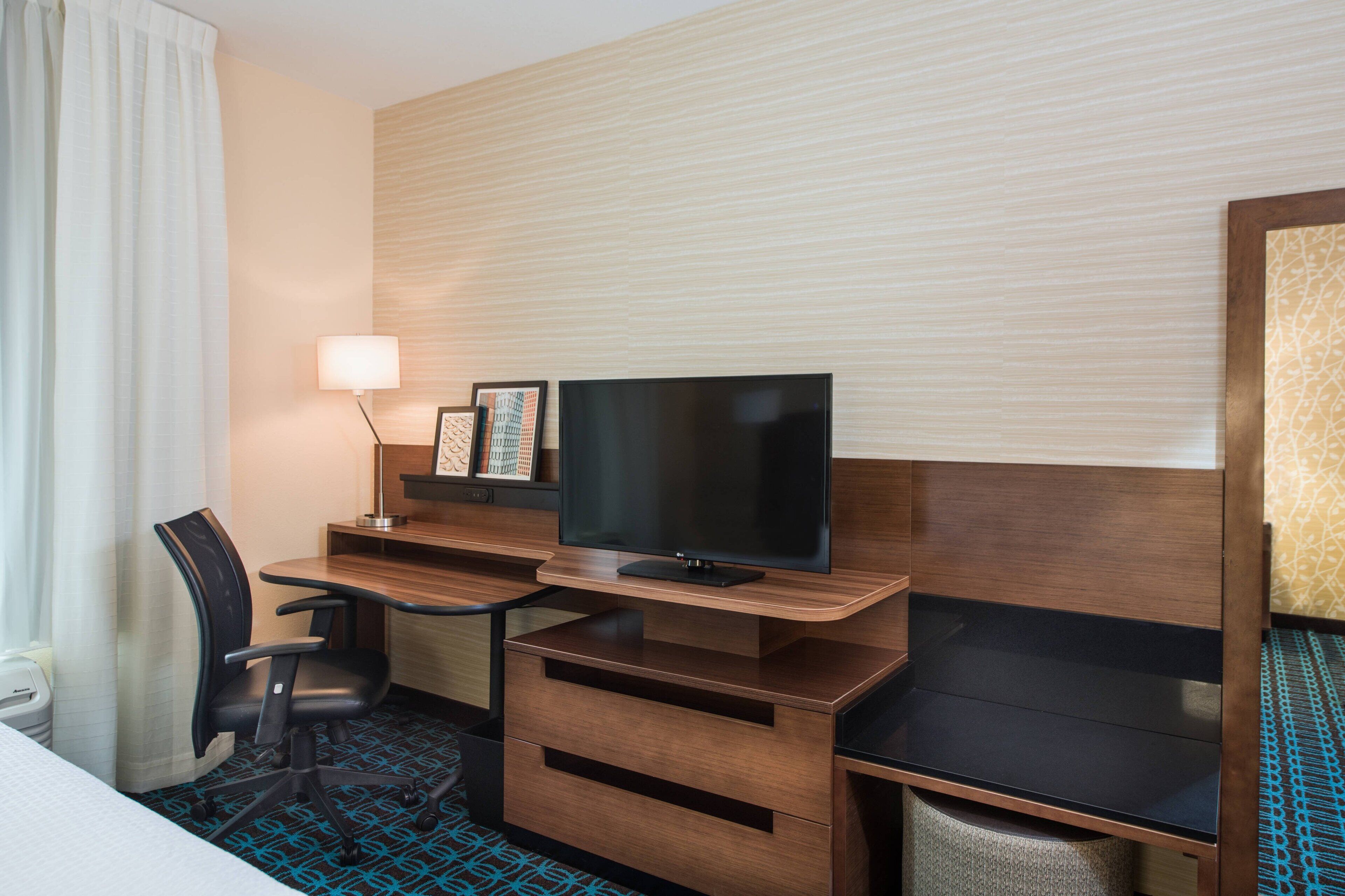 hypo-allergenic bedding, desk, laptop workspace, blackout curtains