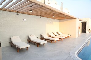 Indoor pool, outdoor pool, open 8 AM to 10 PM, pool loungers