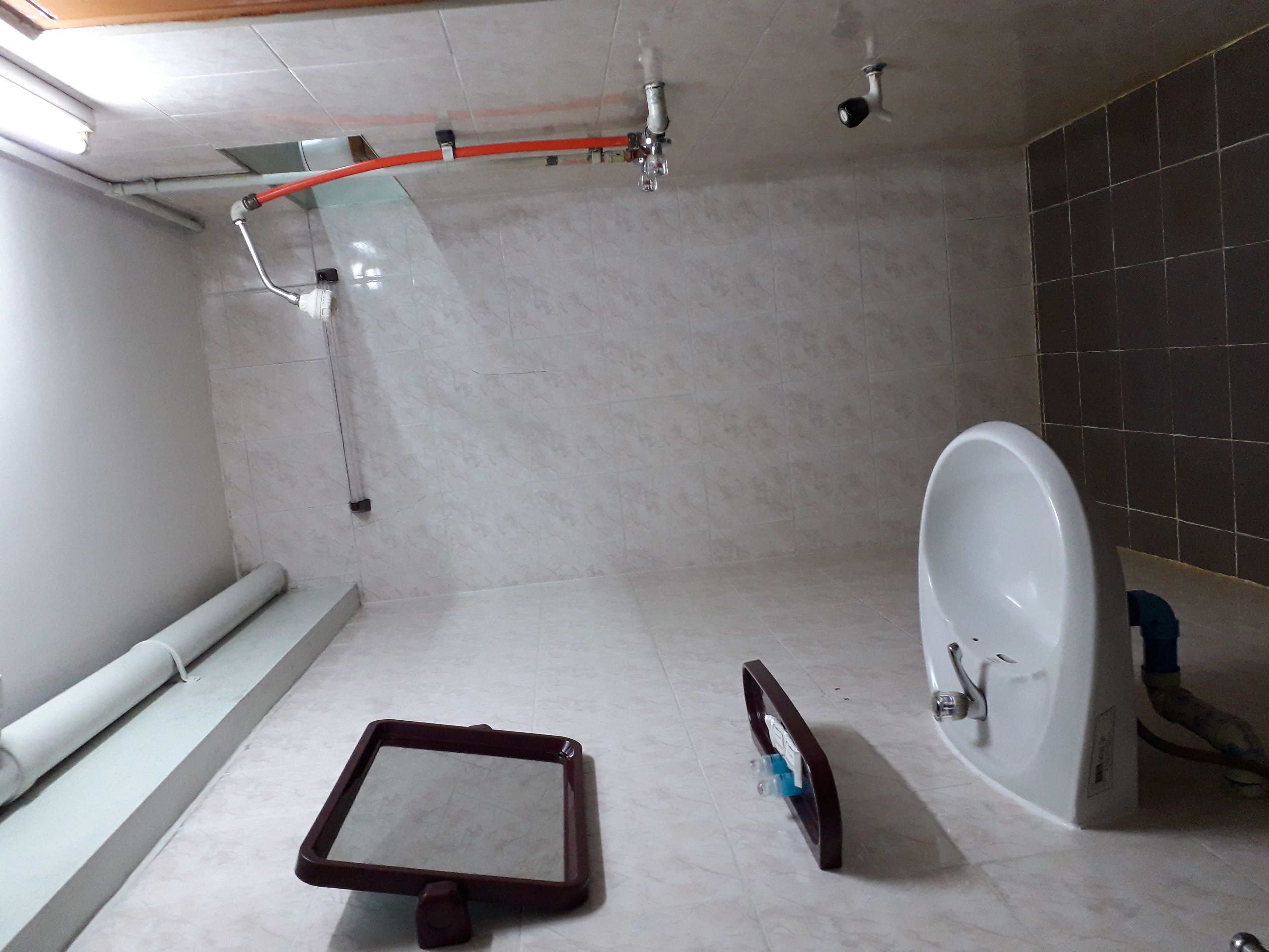 A bathroom with a bathtub, a shower area, and a toilet.