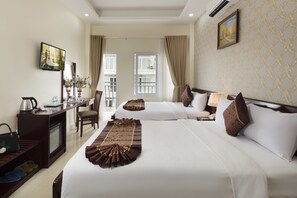 A hotel room with two beds, a desk with a computer, a TV, and a view of the outside. - Hanka Star Hotel (Nha Trang)