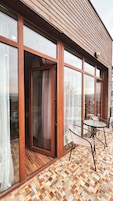 A modern building with large glass windows and a wooden exterior.
