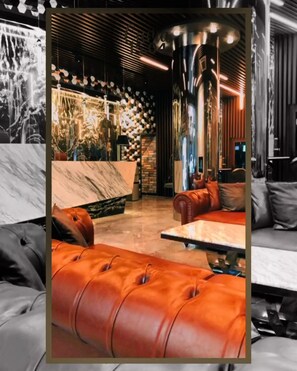 A modern interior with a bar area, leather seating, and a marble countertop. - Grand Hotel Basaran (Bilecik)