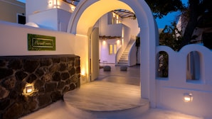 Un edificio moderno con entrada de pared de piedra, una escalera y un letrero que dice 