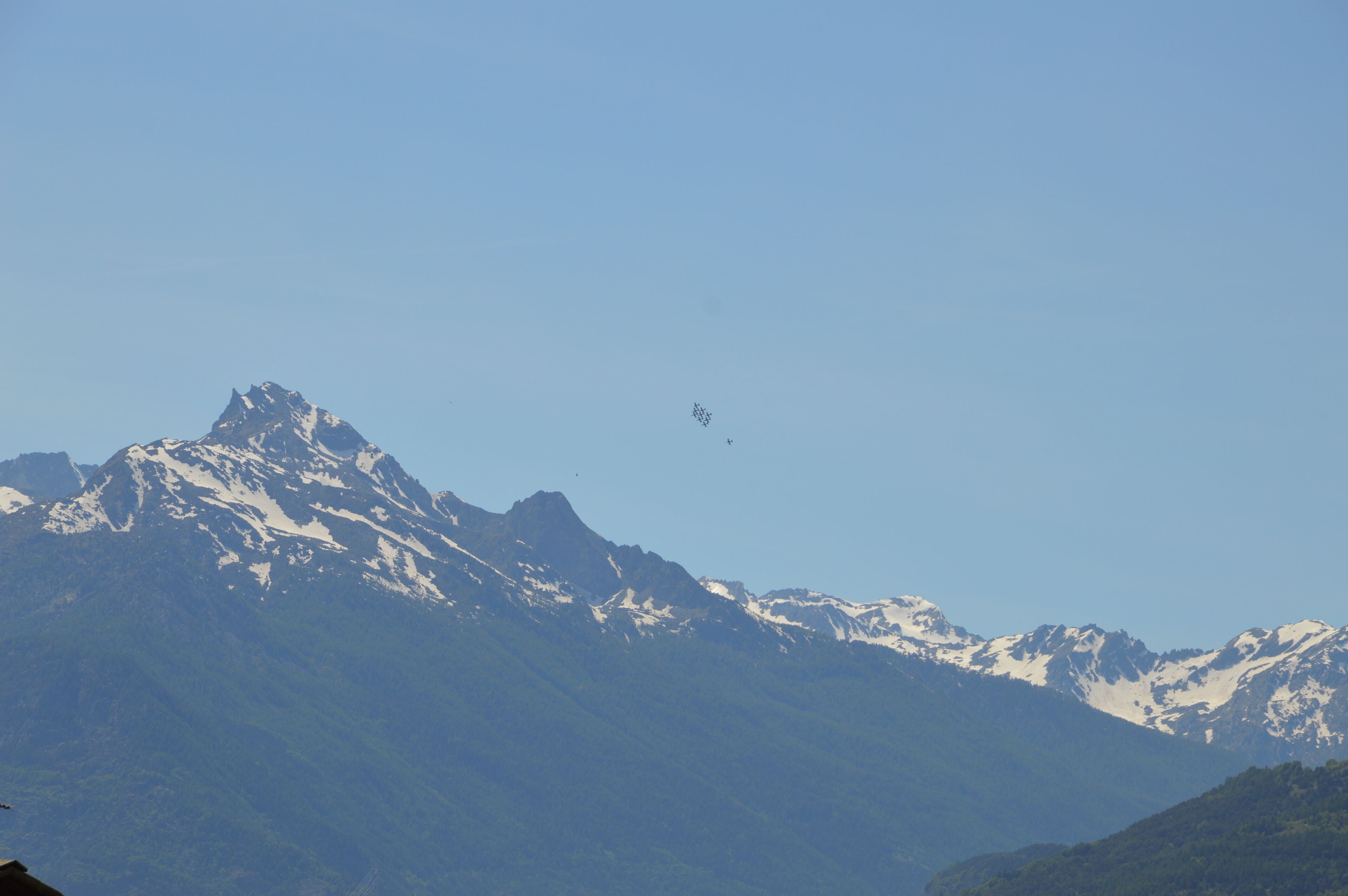 A mountain range with snow-capped peaks and a clear sky.