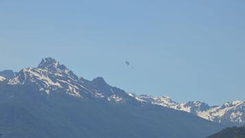 A mountain range with snow-capped peaks and a clear sky.