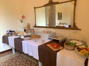 A buffet table with various food items, including pastries, fruits, and condiments. - Villa Scinata Historic House (Nardò)