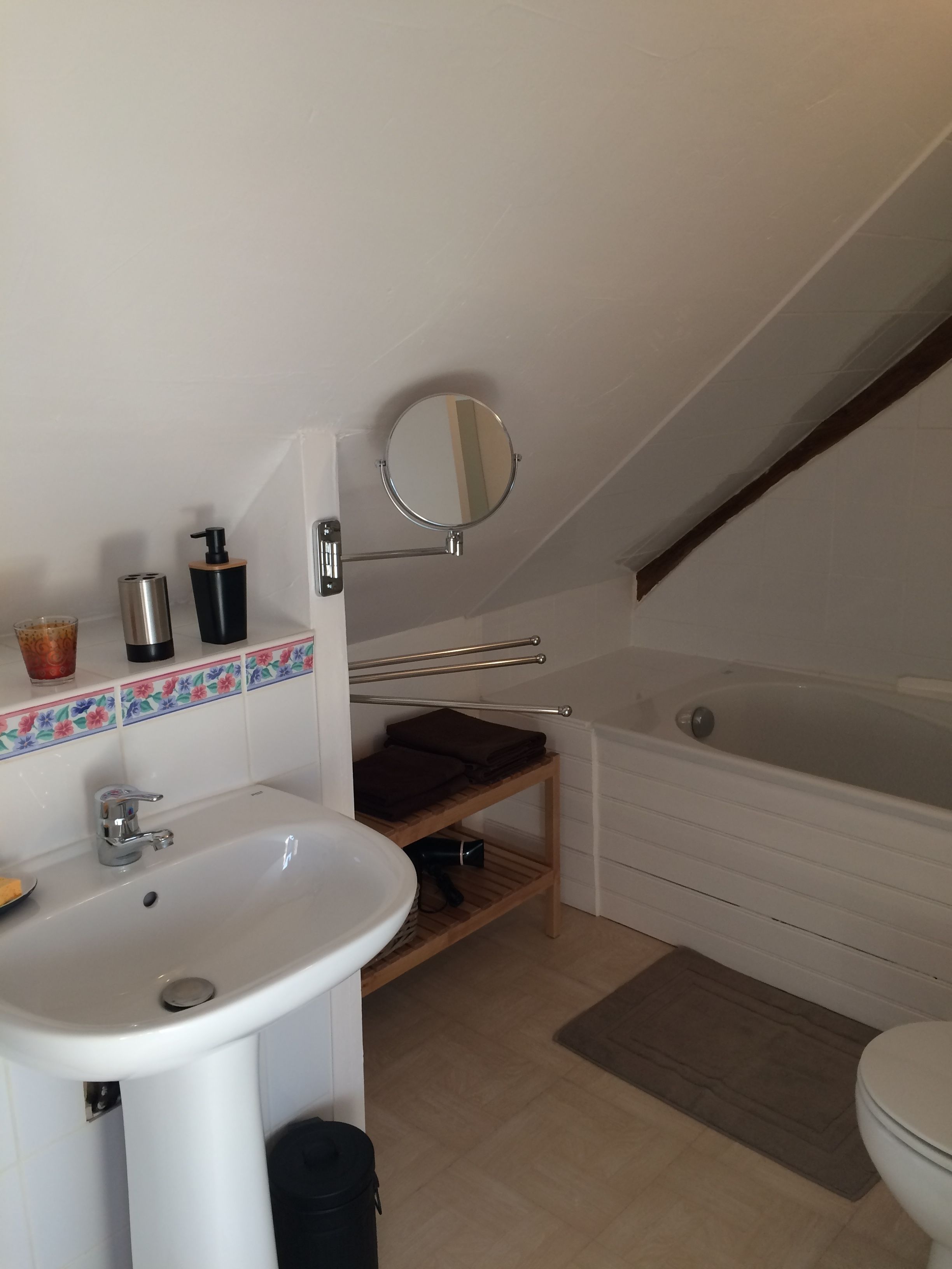 Un baño con lavabo, espejo y bañera.