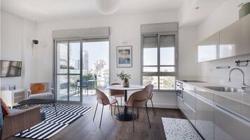 Apartamento exclusivo, várias camas | Área de estar | TV de tela plana 39 polegadas com canais digitais, TV LED