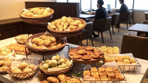 A buffet table with various baked goods, including croissants, muffins, and pastries, in a restaurant setting. - Hotel Relief Sapporo Susukino (Sapporo)