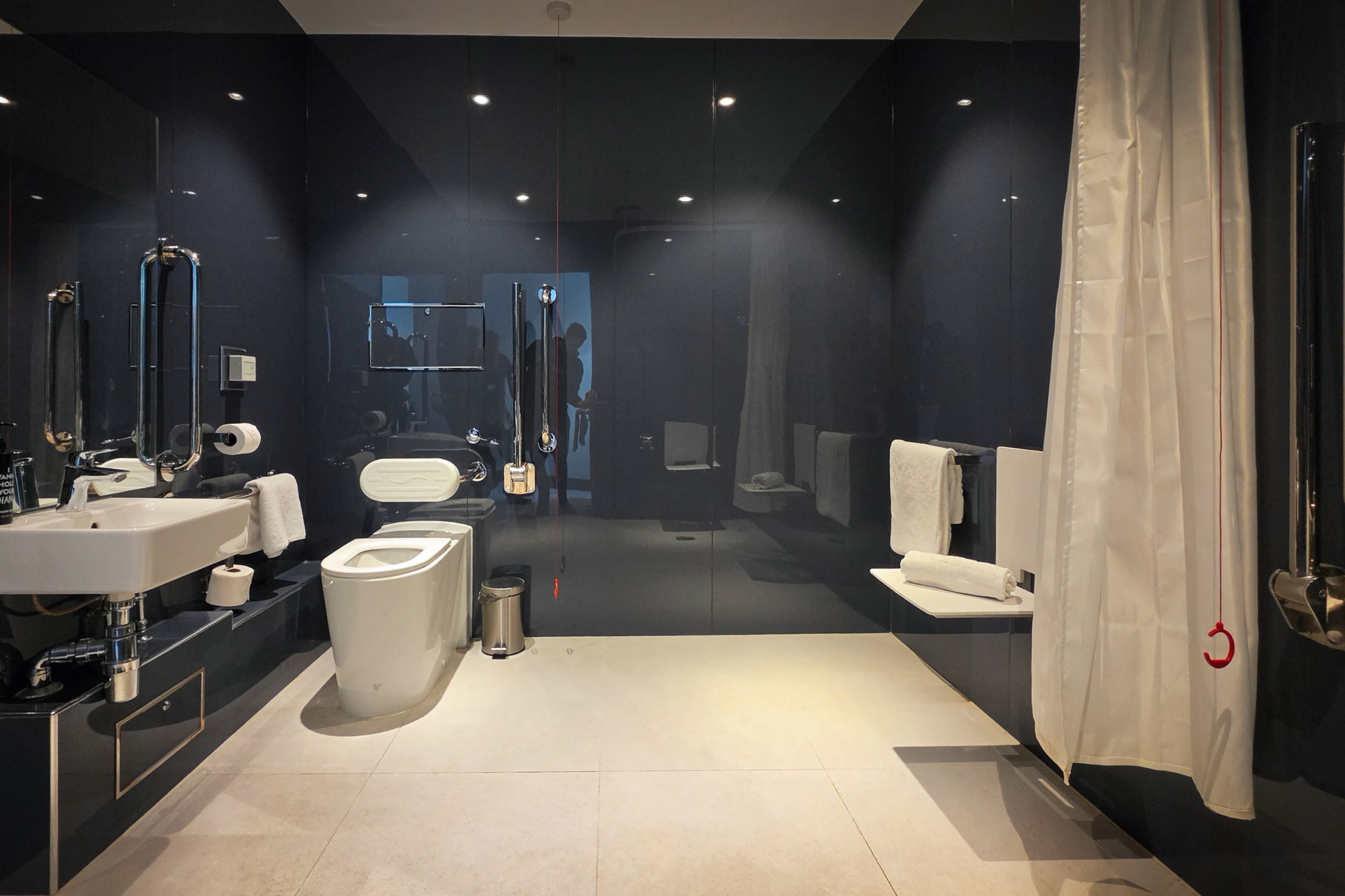 A modern bathroom with a toilet, bidet, and sink.