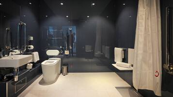 A modern bathroom with a toilet, bidet, and sink.
