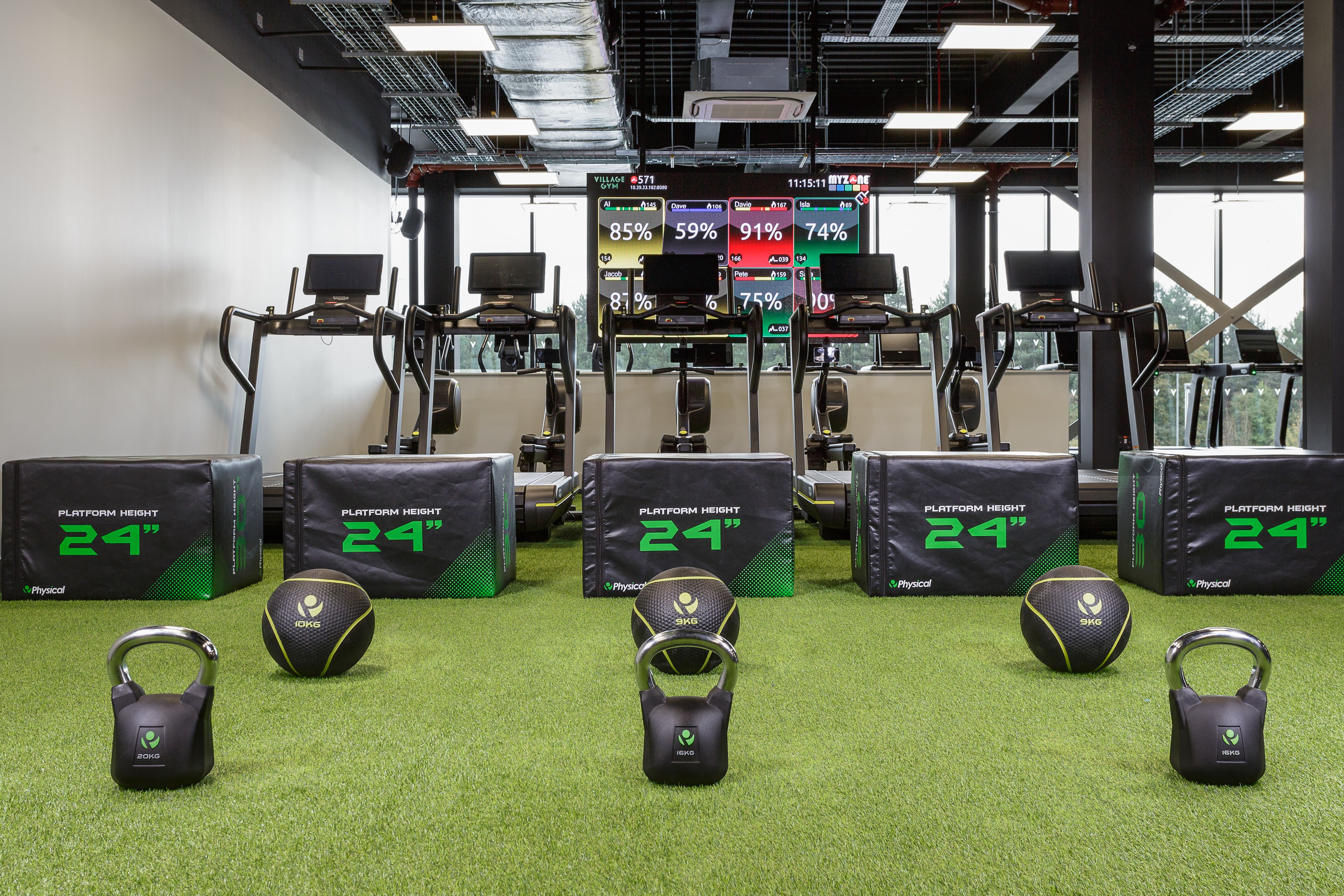 A gym with treadmills, weight machines, and exercise balls.