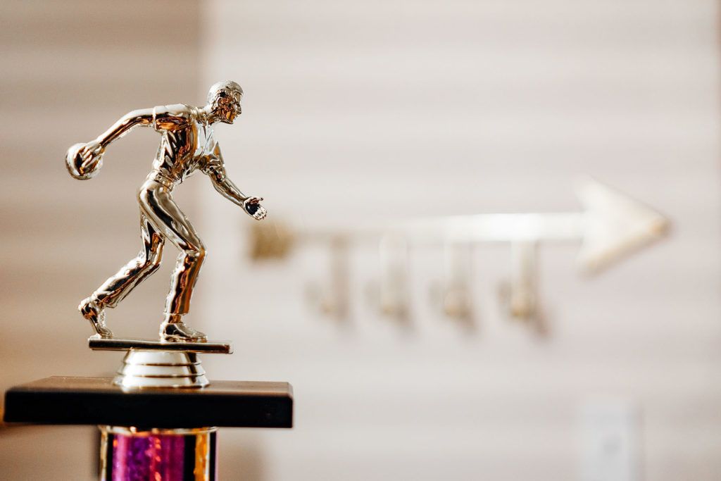 A trophy with a figure on a pedestal.