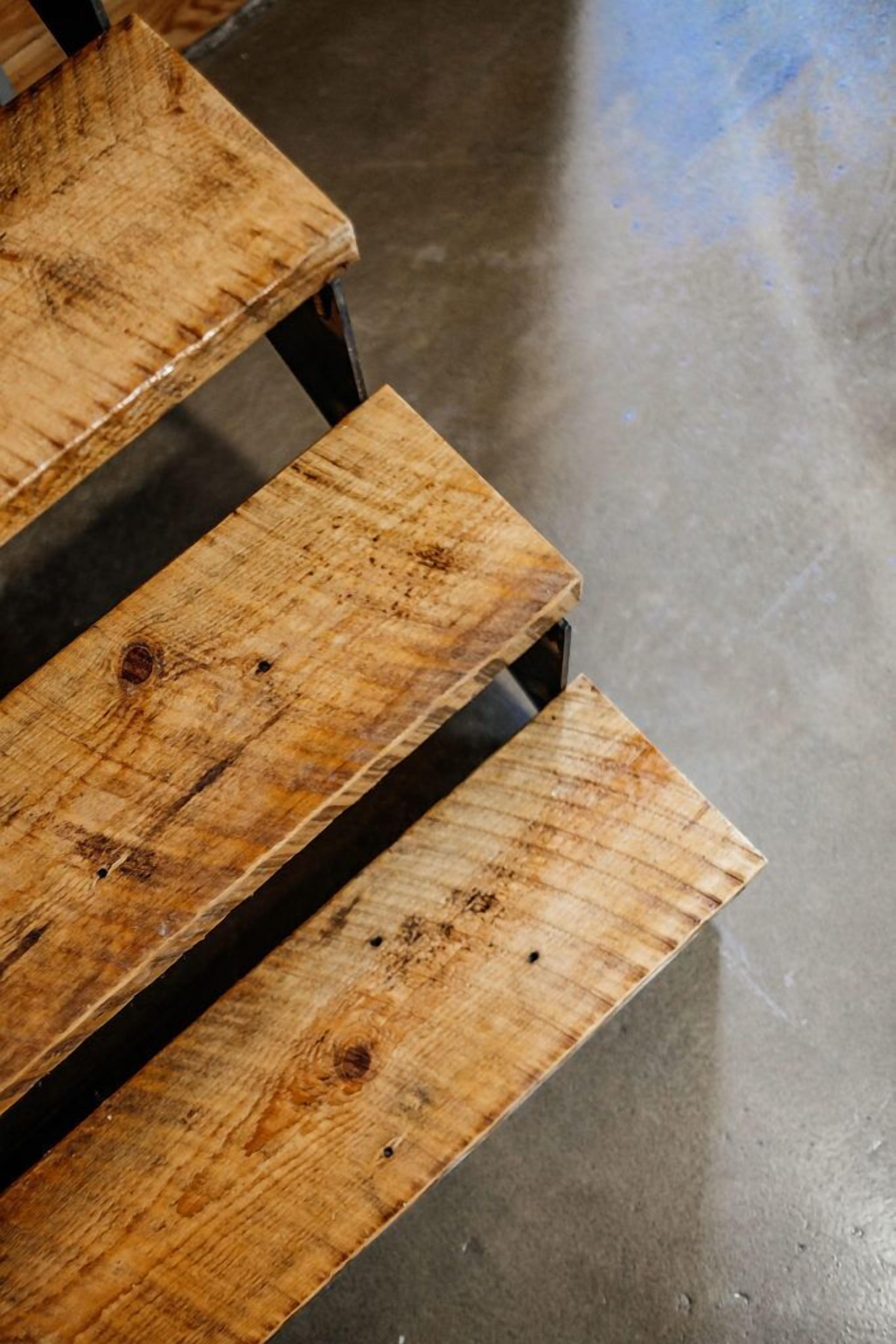 A wooden bench with a metal frame.