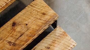 A wooden bench with a metal frame.