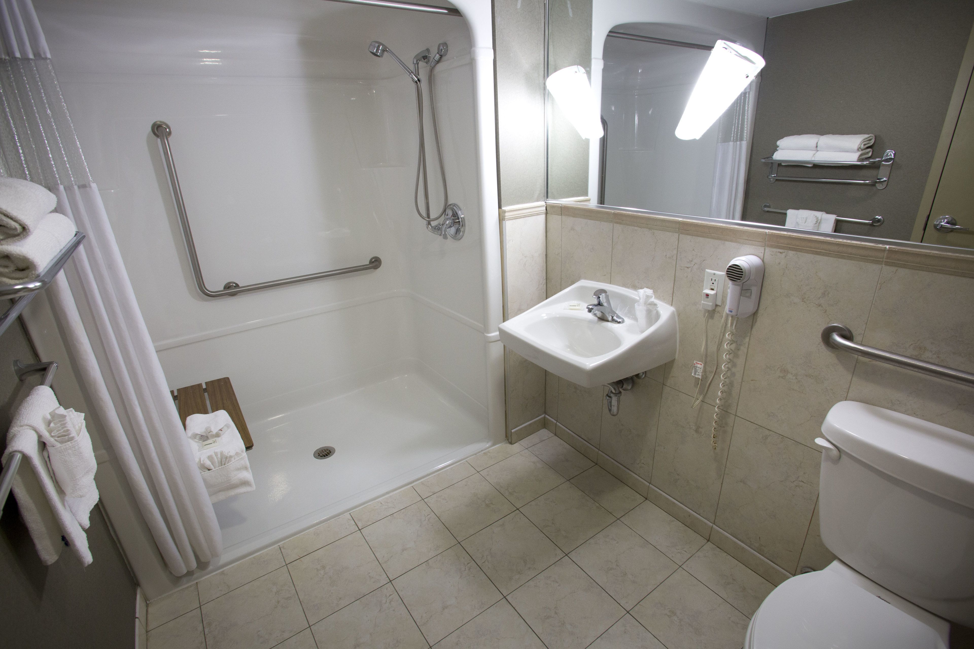 A modern bathroom with a walk-in shower, a sink, and a toilet.
