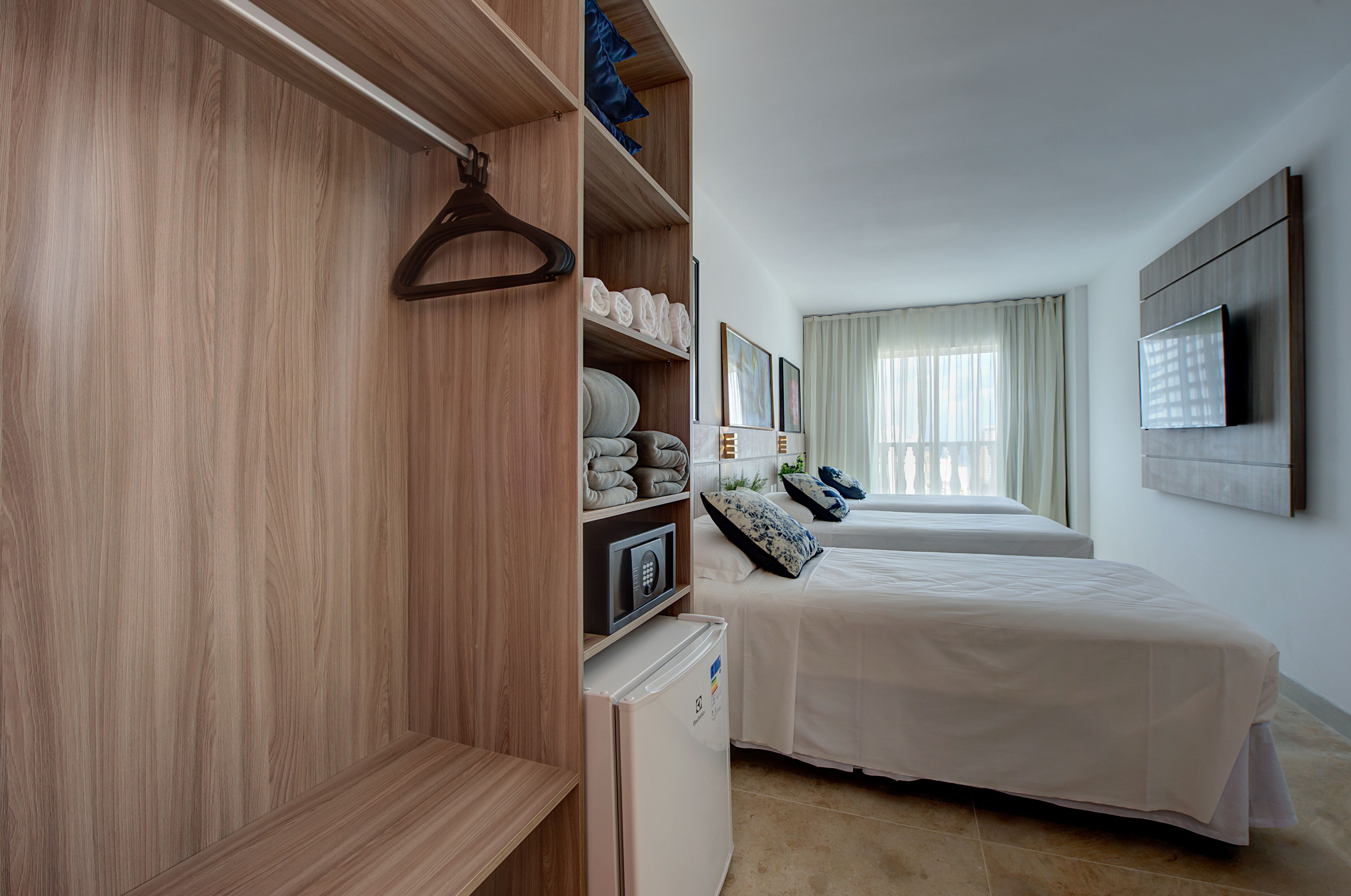 deluxe triple room, sea view | minibar, in-room safe, desk, blackout curtains