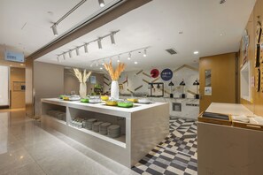A buffet area with a variety of dishes and utensils, a marble floor, and a checkered tile pattern. - Holiday Inn Express Ya'An City Center by IHG (Ya'an)