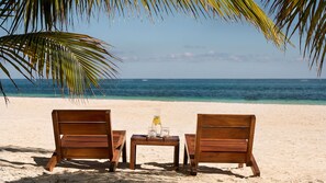 On the beach, white sand, beach umbrellas, beach towels