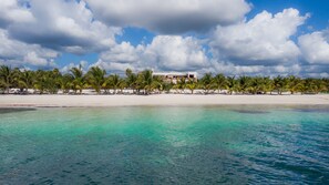 On the beach, white sand, beach umbrellas, beach towels