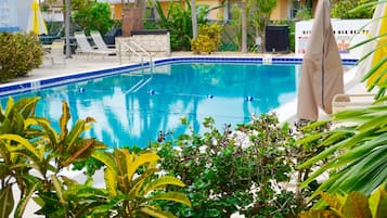 Outdoor pool, a heated pool, free pool cabanas, pool umbrellas