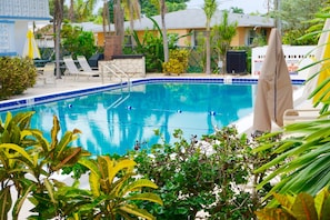 Outdoor pool, a heated pool, free cabanas, pool umbrellas