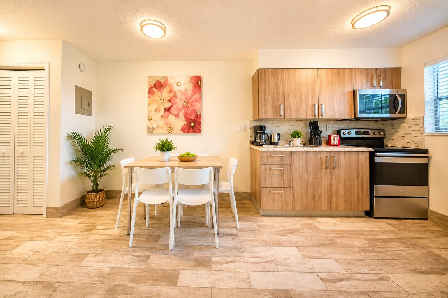 A modern kitchen with wooden cabinets, a stainless steel refrigerator, and a microwave.