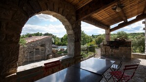 An outdoor patio with stone walls, a wooden ceiling, and a view of a pool and trees. - Independent Mas not overlooked with 10700m2 of enclosed park, 14x4 heated pool  (Labeaume)