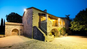 A stone building with a staircase leading to a balcony, surrounded by trees. - Independent Mas not overlooked with 10700m2 of enclosed park, 14x4 heated pool  (Labeaume)