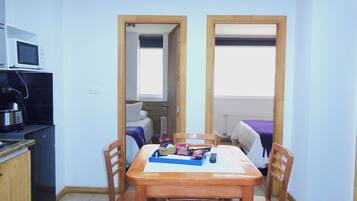 Standard Apartment, 2 Bedrooms, Kitchenette | Living area | Flat-screen TV