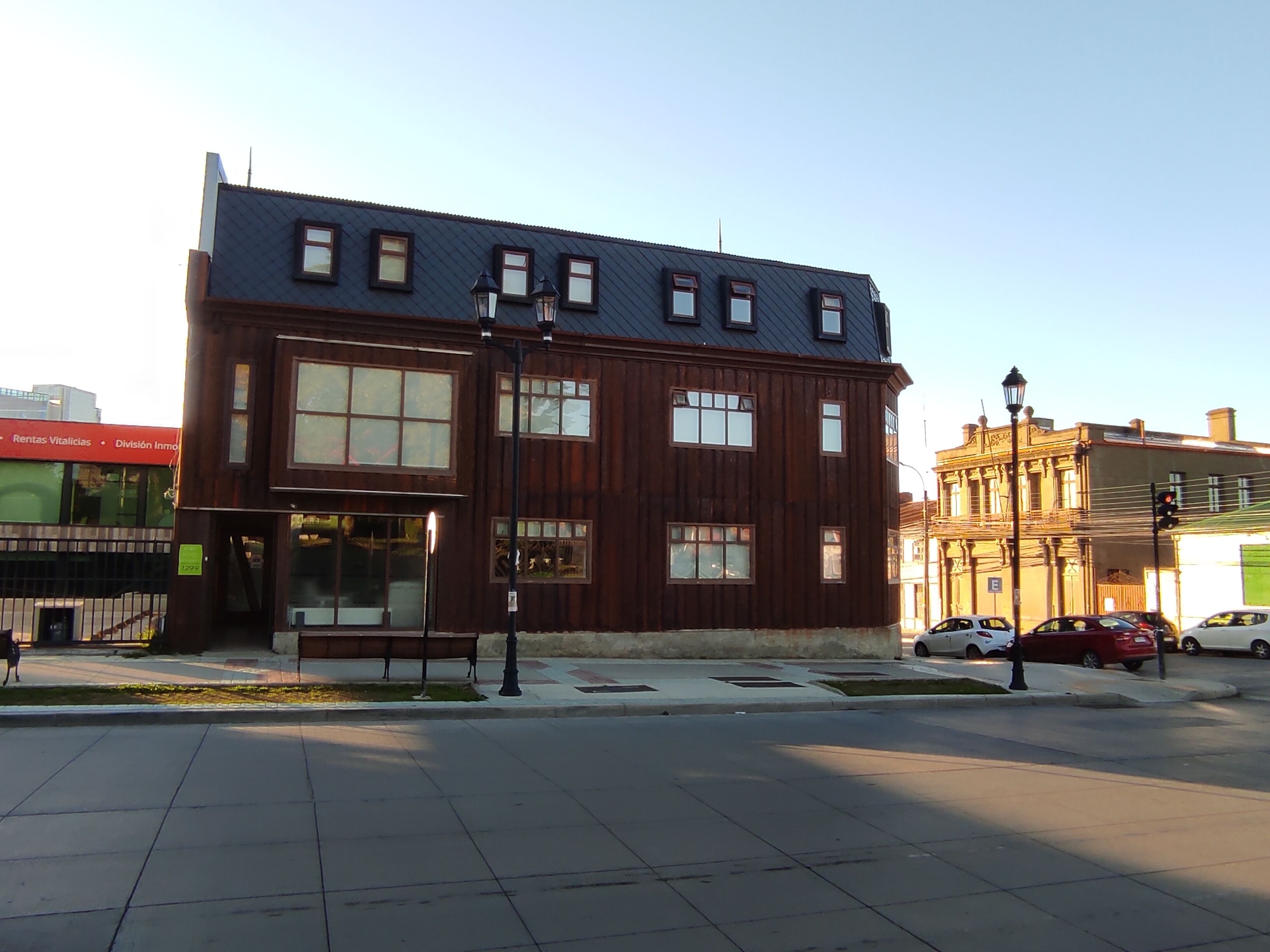 A two-story building with large windows and a flat roof.
