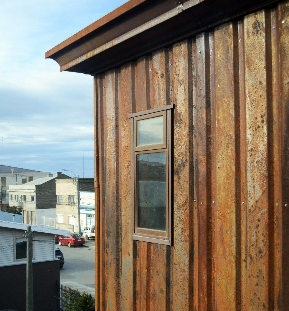 A building with a corrugated metal exterior and a window.