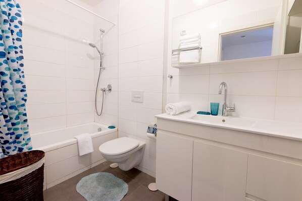 Bathtub, hair dryer, towels