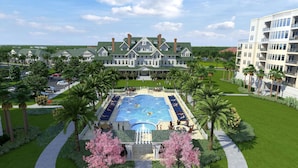 A resort with a swimming pool, palm trees, and a large building with a green roof. - Belleview Inn (Belleair)