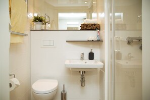A modern bathroom with a toilet, sink, and shower. - LIVStudent Dublin (Dublin)