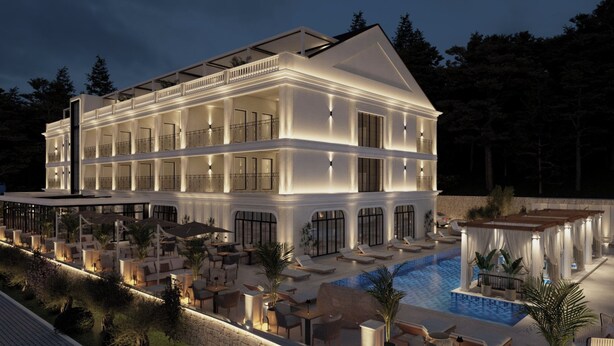 Un hôtel à plusieurs étages doté d’une piscine, d’un espace extérieur aménagé et d’une terrasse couverte.