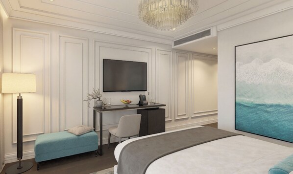 A hotel room with a bed, a desk with a chair, a television, and a large painting of a wave.