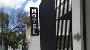 A hotel entrance with a black gate and a sign that reads "HOTEL". - Casa Zapopan Hotel (Zapopan)