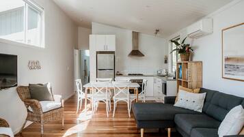 Deluxe Cabin, 2 Bedrooms | Living area | 32-inch Smart TV with digital channels