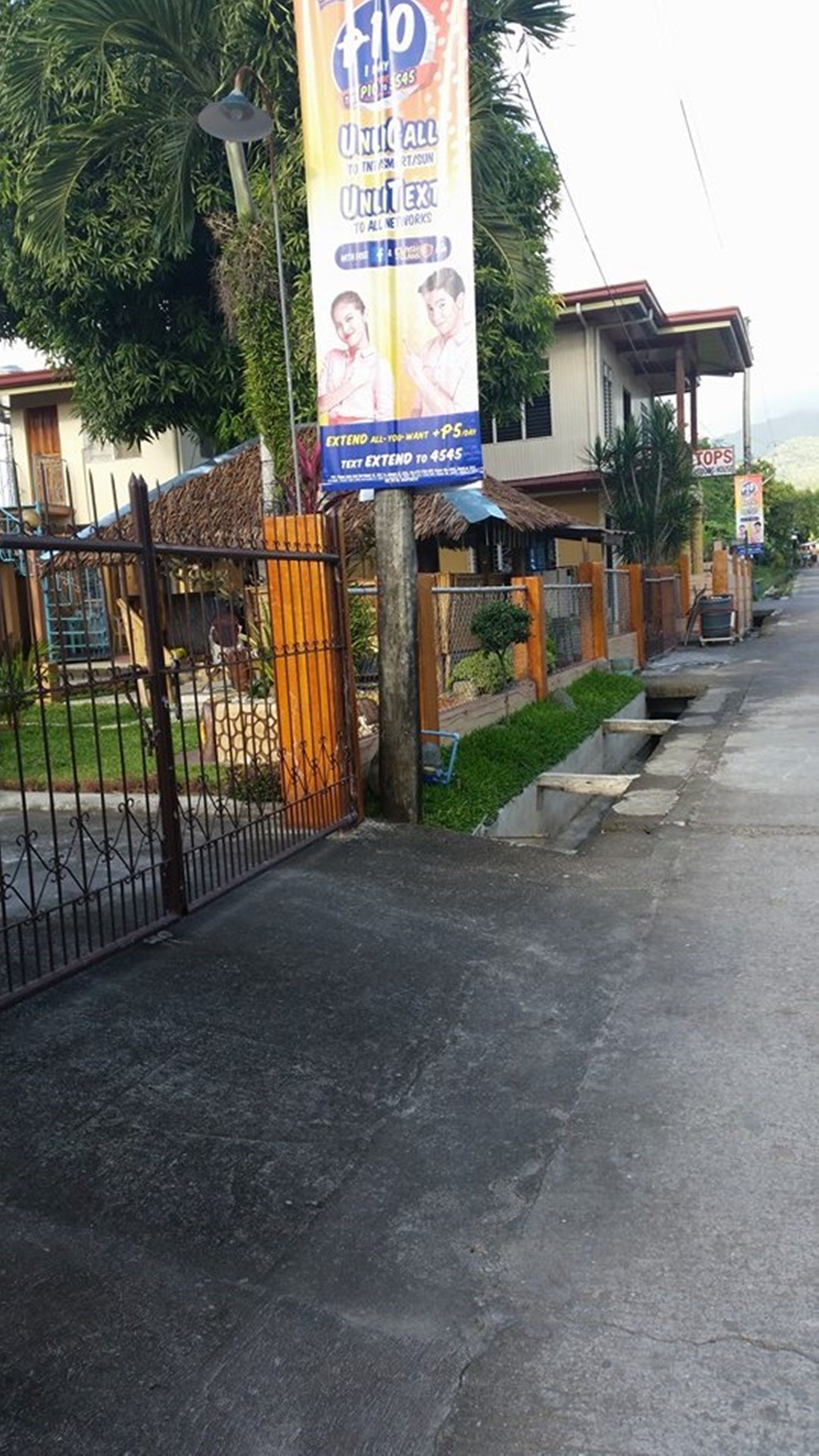 A gated area with a banner advertising a mobile service.
